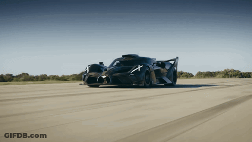 A Black Sports Car With A White X On The Side Of It GIF