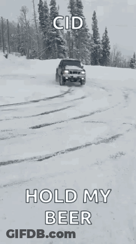 A Black Truck Is Driving Through The Snow With The Words Hold My Beer Written On The Bottom GIF