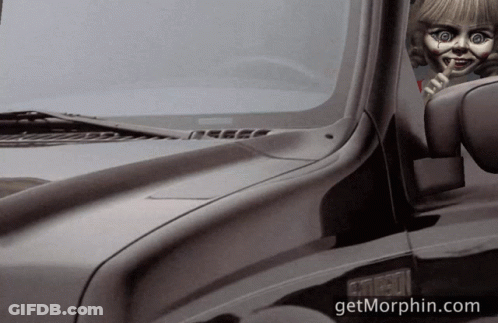 A Black Truck With A Doll Sticking Out Of The Window And The Website Getmorphin.com GIF