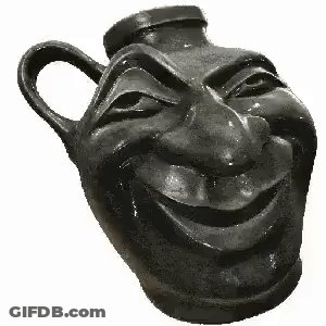 A Black Vase With A Smiling Face Carved Into It . GIF