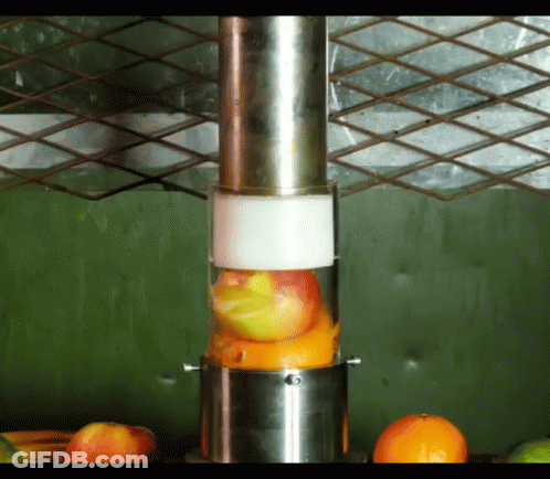 A Blender Is Filled With Fruit Including Oranges GIF