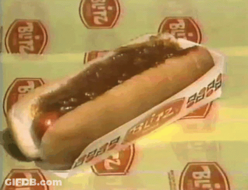 A Blitz Hot Dog Is Sitting On A Yellow Surface GIF