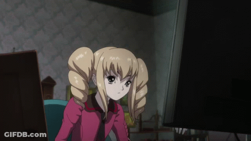 A Blonde Anime Girl With Pigtails Is Sitting In Front Of A Computer Monitor GIF