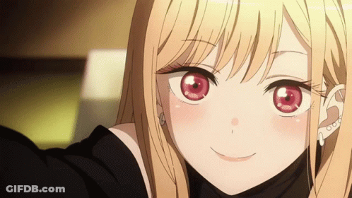 A Blonde Anime Girl With Red Eyes Is Smiling For The Camera GIF