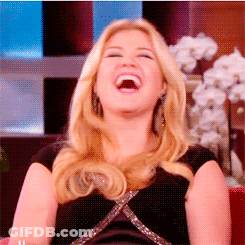 A Blonde Woman Is Laughing With Her Mouth Open GIF