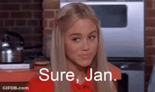 A Blonde Woman Is Sitting In A Kitchen With The Words `` Sure , Jan . '' Written On Her Face . GIF