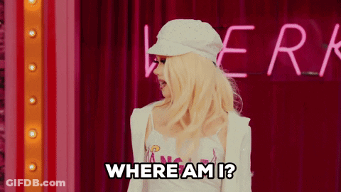 A Blonde Woman Is Standing In Front Of A Neon Sign That Says " Where Am I " GIF