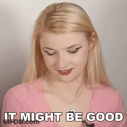 A Blonde Woman Is Wearing A Pink Shirt And Necklace And Says It Might Be Good . GIF