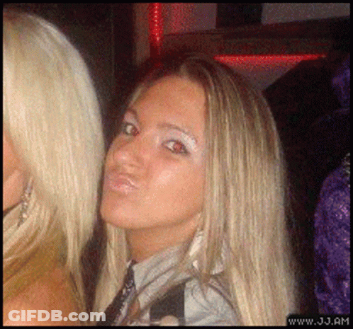 A Blonde Woman Making A Funny Face Next To Another Blonde Woman With The Website Www.jj.am Visible In The Corner GIF