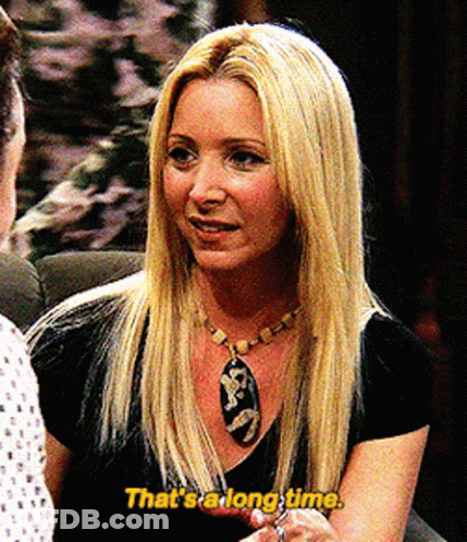A Blonde Woman Says That 'S A Long Time In Yellow Letters GIF
