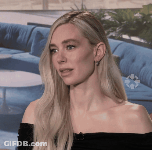 A Blonde Woman Wearing A Black Off The Shoulder Top GIF