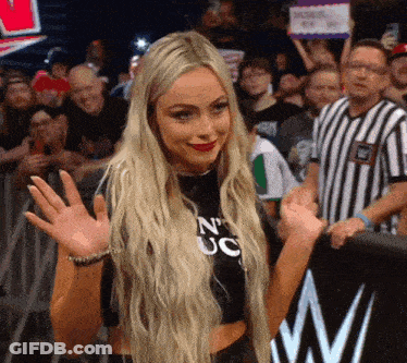 A Blonde Woman Wearing A Black Shirt That Says N' Uc GIF