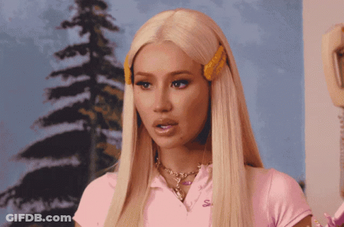 A Blonde Woman Wearing A Pink Shirt With The Letter S On The Front GIF
