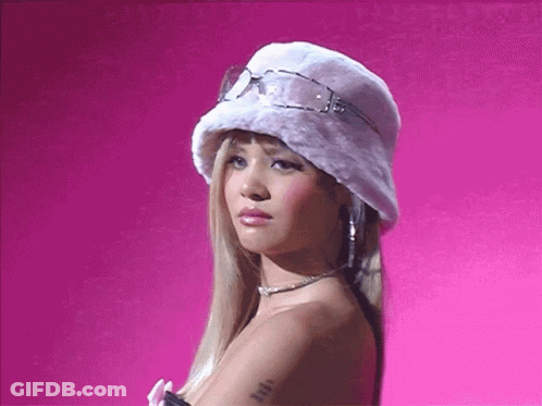 A Blonde Woman Wearing A White Hat And Sunglasses GIF