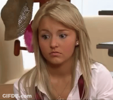 A Blonde Woman Wearing A White Shirt And A Red Tie Is Looking At The Camera . GIF