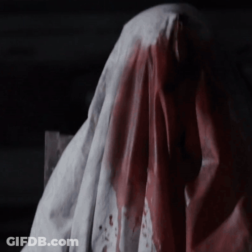 A Bloody Cloth Is Covering A Person 'S Head GIF