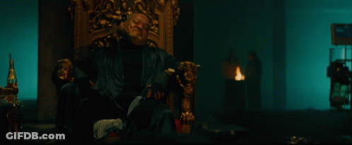 A Bloody Hand Is Reaching Out Towards A Man Sitting In A Chair GIF