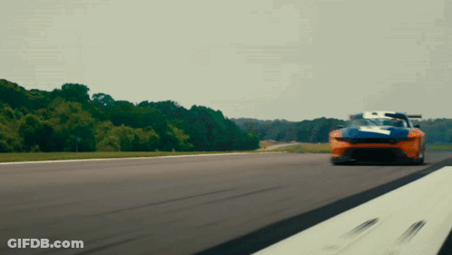 A Blue And Orange Race Car With The Number 7 On It GIF