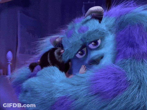 A Blue And Purple Furry Monster With Horns Is Hugging Another Monster GIF
