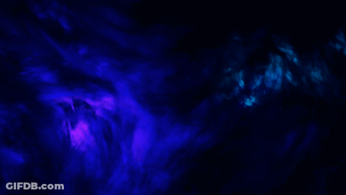 A Blue And Purple Smoke Coming Out Of A Dark Background GIF