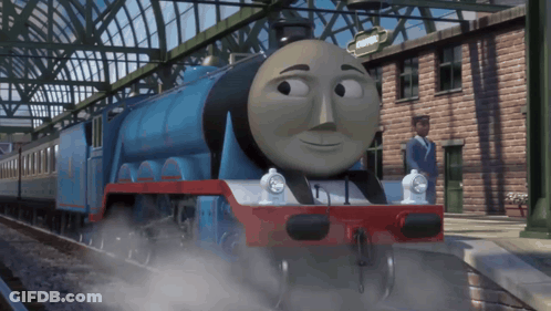 A Blue And Red Train With A Sign That Says " Kings Cross " GIF