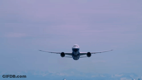 A Blue And White Airplane Flying In The Sky With The Number 777 On The Front GIF