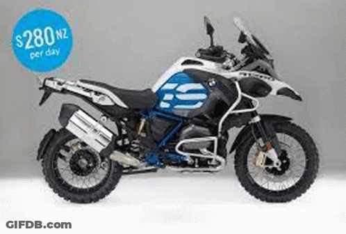 A Blue And White Bmw Gs Adventure Motorcycle Is Sitting On A White Surface . GIF