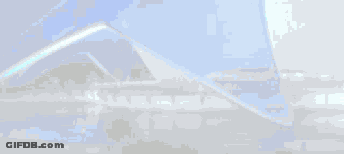 A Blue And White Building With A Reflection Of The Building In The Water . GIF