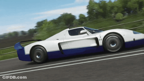 A Blue And White Sports Car Is Driving Down The Road GIF