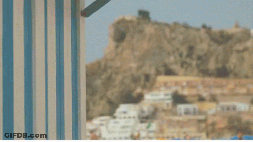 A Blue And White Striped Wall With A Red Crab In The Background GIF