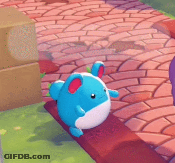 A Blue And White Stuffed Animal Is Sitting On A Bench With A Speech Bubble That Says " Nom Nom Nom " GIF
