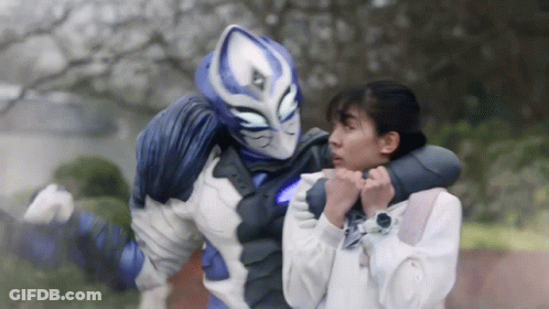 A Blue And White Superhero Is Holding A Woman In His Arms GIF