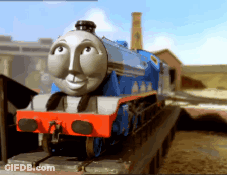A Blue And White Train With A Face On The Front Of It GIF