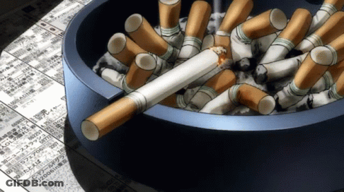 A Blue Ashtray Filled With Cigarettes And A Broken Cigarette On Top GIF