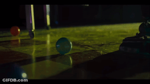 A Blue Ball Is Being Thrown Into A Green Liquid GIF