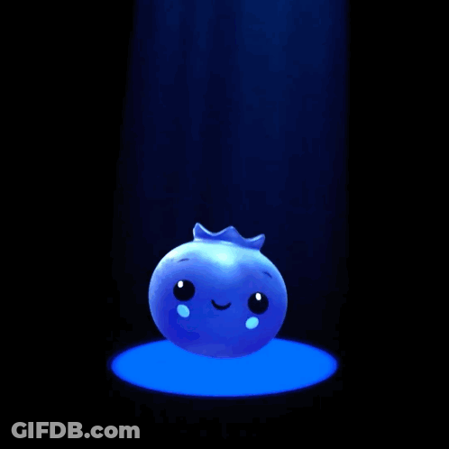 A Blue Ball With A Face On It Is Sitting In A Spotlight GIF