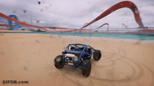 A Blue Buggy Is Driving Down A Sandy Beach GIF