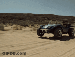 A Blue Buggy Is Driving Through A Sandy Desert GIF
