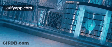 A Blue Building With A Fence In Front Of It And The Words Kulfyapp.com On The Bottom . GIF
