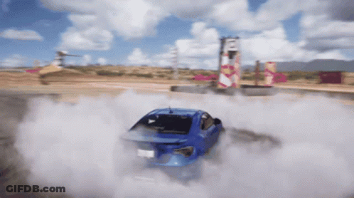 A Blue Car Is Drifting On A Dirt Track GIF