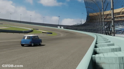 A Blue Car Is Driving Down A Race Track With A Fence Around It GIF