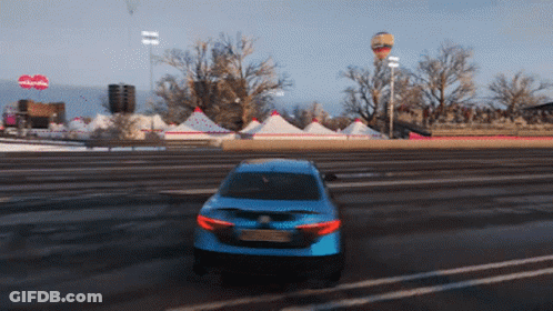 A Blue Car Is Driving Down A Road In Front Of A Sign That Says Nickelodeon GIF