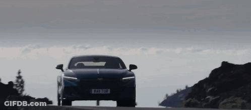 A Blue Car Is Driving Down A Road With A License Plate That Says ' Aao 108 ' On It GIF