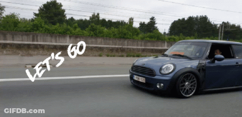 A Blue Car Is Driving Down A Road With The Words Let 'S Go Written On The Side GIF