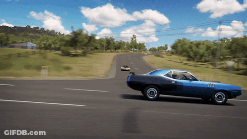 A Blue Car Is Driving Down A Road With Trees In The Background GIF