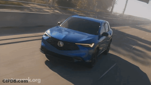 A Blue Car Is Driving On A Highway With Motorweek.org Written On The Bottom GIF