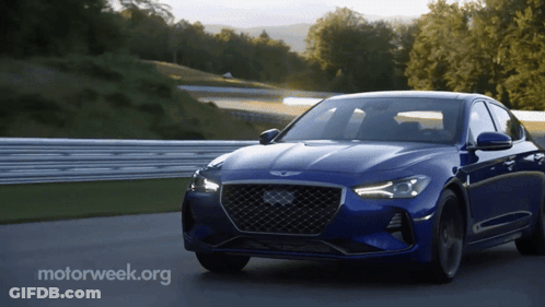 A Blue Car Is Driving On A Road With Motorweek.org Written On The Bottom Right GIF