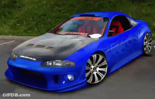 A Blue Car Is Parked In A Parking Lot And Has A Sticker On The Windshield That Says Spitfire On It GIF