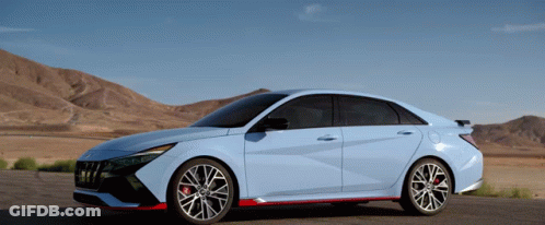 A Blue Car Is Parked On The Side Of A Road GIF