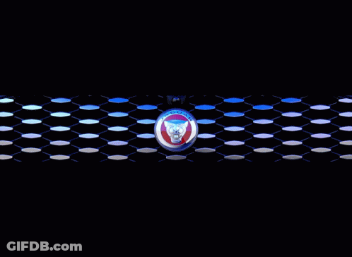 A Blue Car With A Jaguar Emblem On The Front GIF